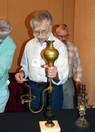Photo of Heinz Baumann holding a vapor lamp